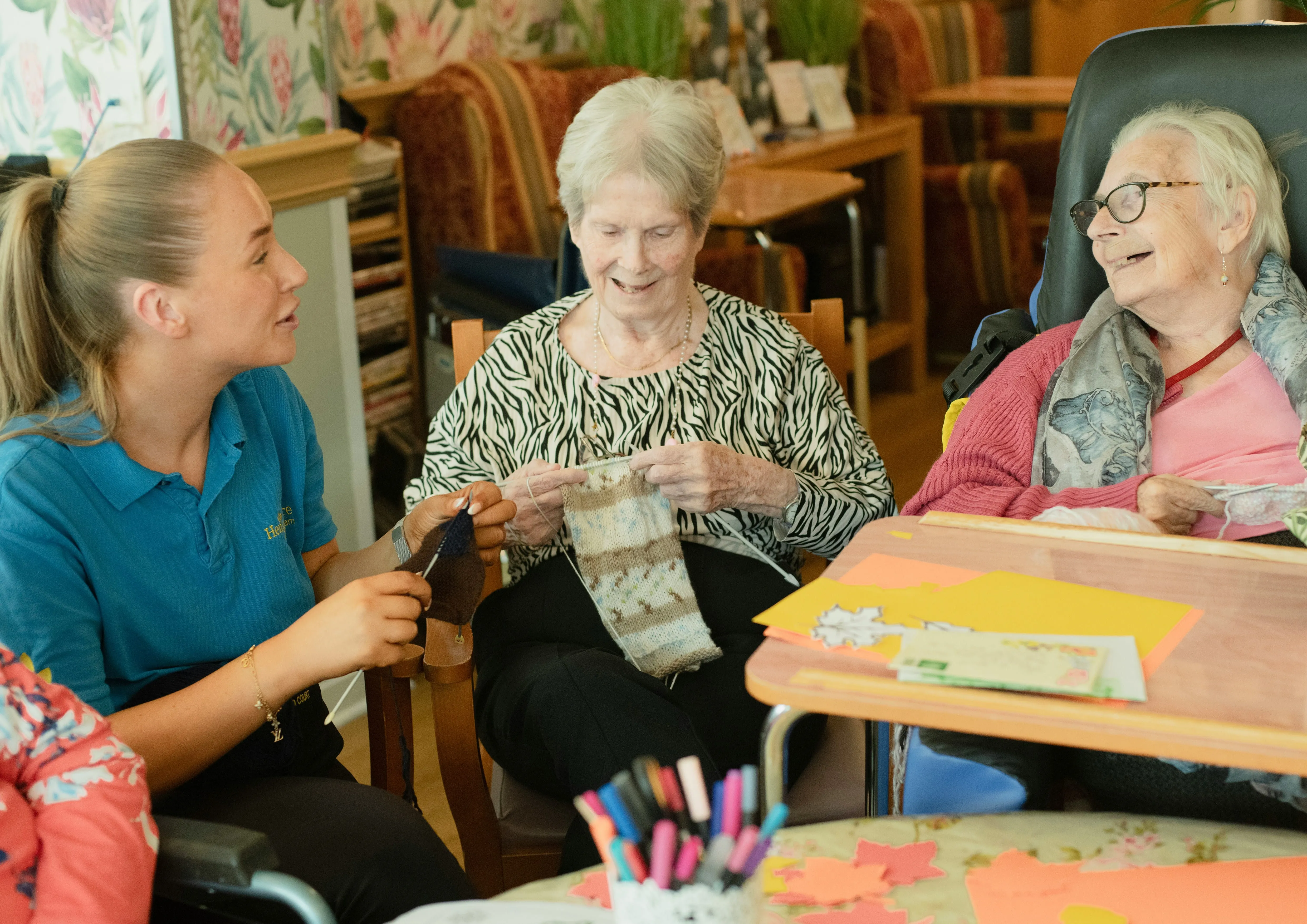 Two people sharing a warm conversation over tea, laughing together
